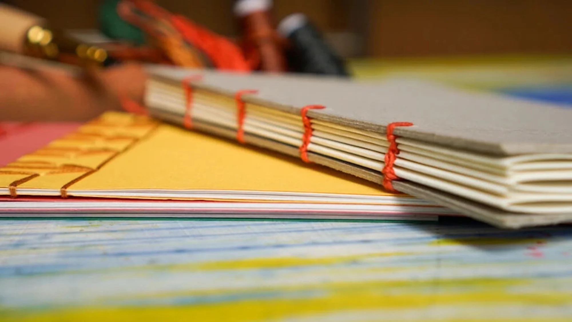 Yellow and grey notebooks on a table