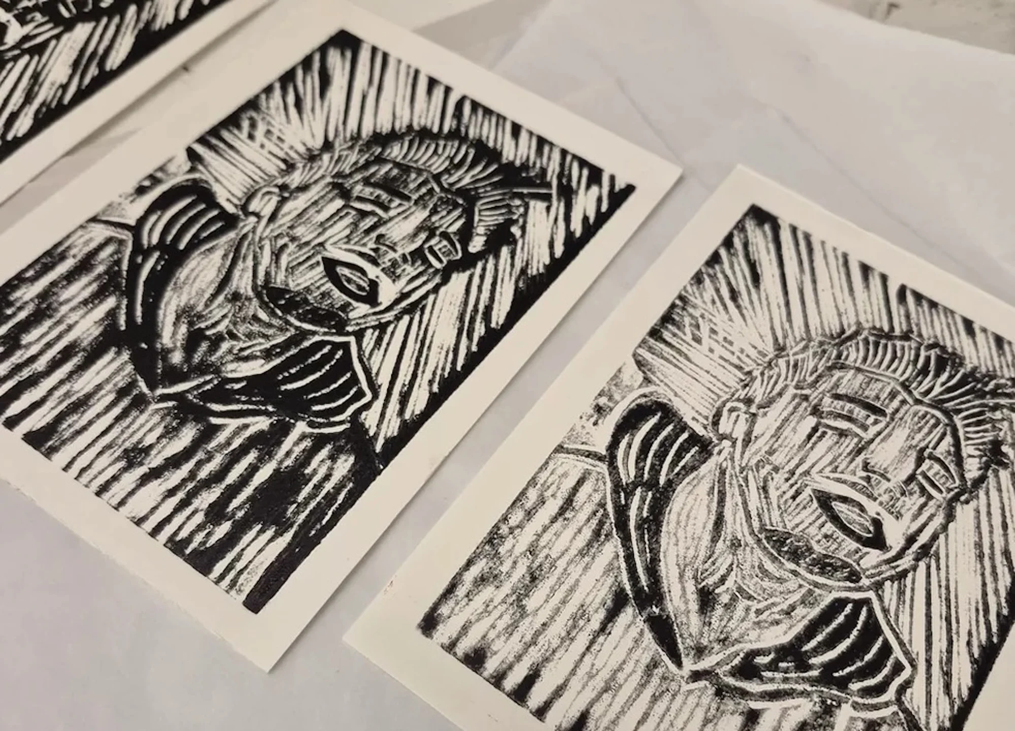 Carved wood blocks with people's faces etched into them