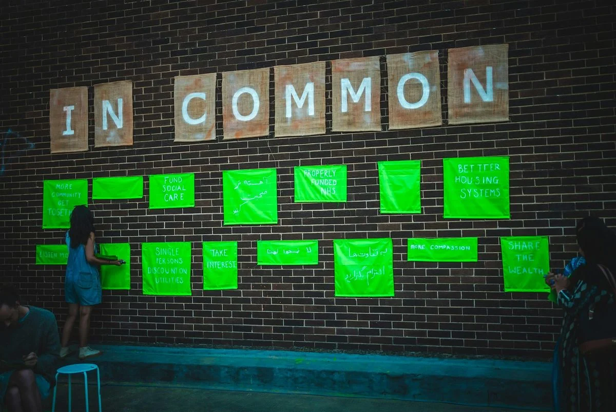 A brick wall with individual letters on reading In Common